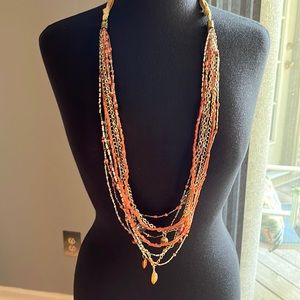 Beachy look with coral colors nine strand necklace